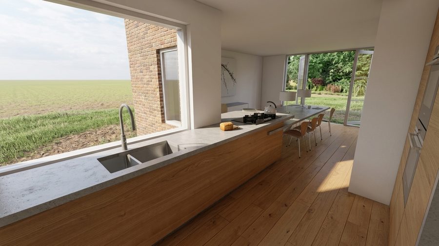 Keuken met een lang werkblad langs het raam en zicht op de achtertuin